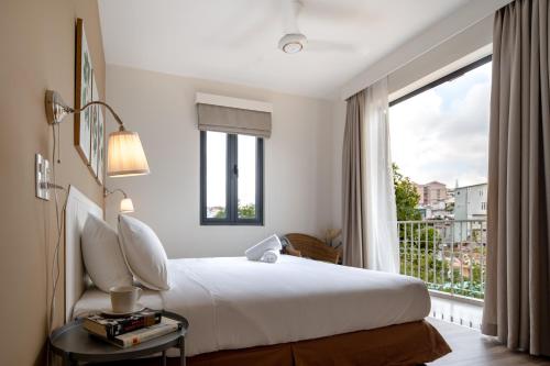 a bedroom with a bed and a large window at La Em Boutique Villa in Da Lat