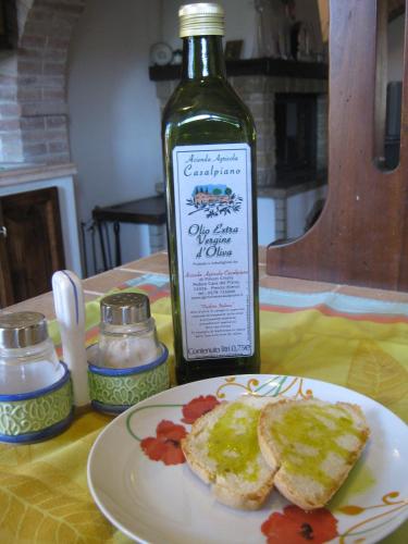 a bottle of wine sitting next to a plate of food at Agriturismo Casalpiano in Pienza