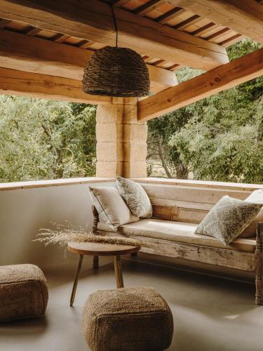 a porch with a couch and a table at Mas Generós - Adults-Only Eco Hotel in Fonteta