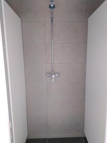 a shower with a glass door in a bathroom at Napfény Camping in Taliándörögd