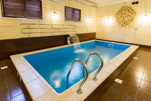 a jacuzzi tub in a bathroom with two handles at Hotel&Restaurant Premium Club in Yaremche