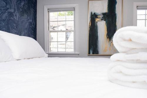 a white bed in a room with a window at * Midcentury Modern Getaway * Prime Location * in Annapolis
