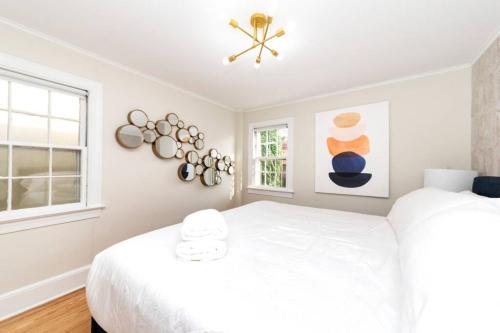 a white bedroom with a bed and a window at * Midcentury Modern Getaway * Prime Location * in Annapolis