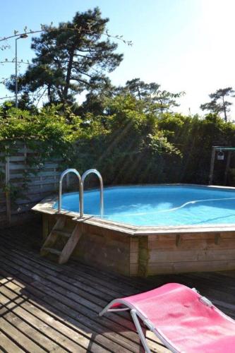 - une grande piscine avec un banc à côté dans l'établissement Villa Uhaïna Hossegor, à Hossegor