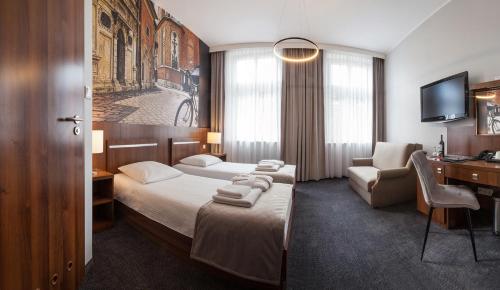Posteľ alebo postele v izbe v ubytovaní Hotel Downtown Kraków