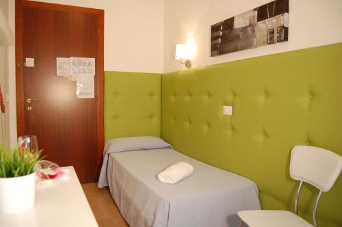 a small room with two beds and a table at Hotel Irene in Lignano Sabbiadoro