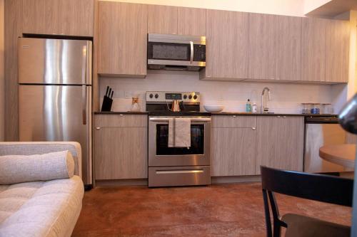 a kitchen with a stainless steel stove and refrigerator at Mayor's Study Loft at Kestrel Hotel in Philadelphia