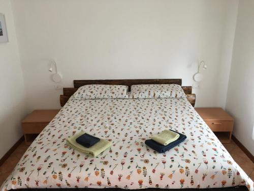 a bedroom with a bed with two pillows on it at Baita Dal Vikingo in Sorico