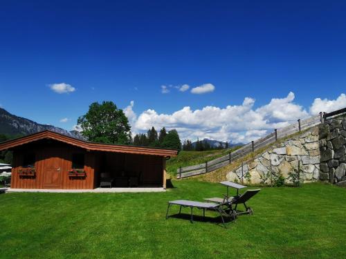 a picnic table and a bench in front of a building at KOASALIFE in Going