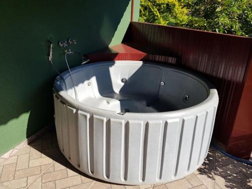 a large white bath tub sitting next to a wall at Fazenda Coronel Jacinto in Bragança Paulista