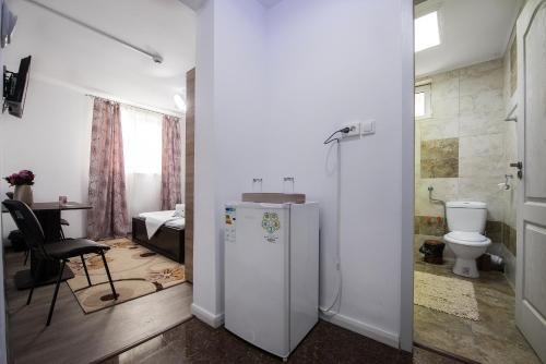 a living room with a refrigerator and a toilet at Eden House in Costinesti