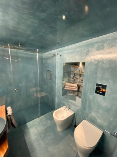 a bathroom with a toilet and a sink and a shower at Il cortile di Elen in Marsala