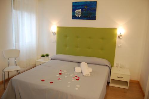 a bedroom with a bed with roses on it at Hotel Irene in Lignano Sabbiadoro