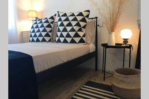 a bedroom with a bed with blue and white pillows at Traditional Stone House in Eastern Mani in Flomokhórion