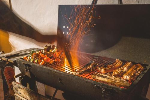 a grill with a bunch of food on it at Agüita House in Las Palmas de Gran Canaria