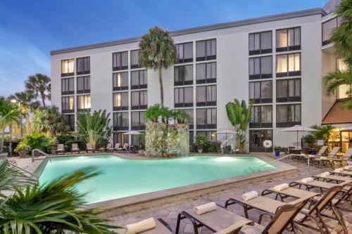 a swimming pool in front of a hotel at Doubletree by Hilton Fort Myers at Bell Tower Shops in Fort Myers