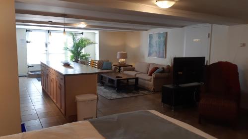 a kitchen and living room with a couch and a table at Parkside House in Barrie