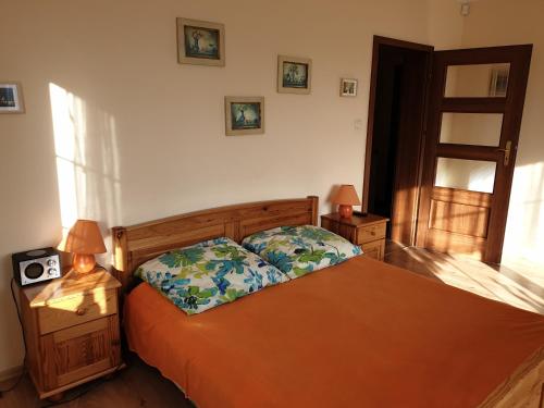 a bedroom with a bed and two lamps and a window at Apartamenty i pokoje u Beaty in Augustów
