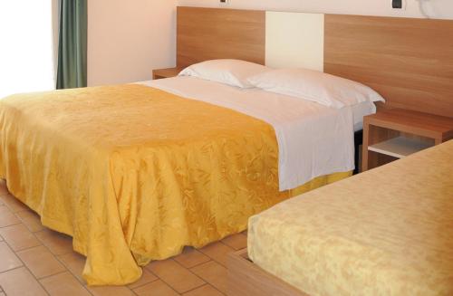 Een bed of bedden in een kamer bij Hotel Edera