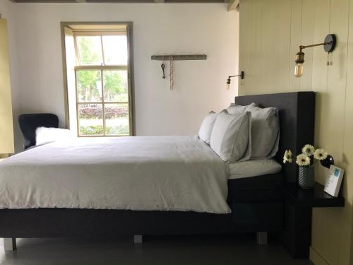 Postel nebo postele na pokoji v ubytování B&B In het Voorhuys