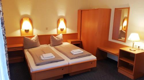 a hotel room with a bed and a mirror at Hotel Altberesinchen in Frankfurt/Oder