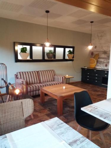 a living room with a couch and a table at Haus S.E.E. in Marienthal