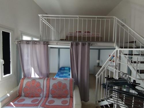 a room with a bunk bed and a ladder at Appartamento SeaLife in San Foca