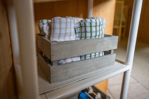 two wooden boxes with towels on a shelf at Holiday Home Srednja vas in Srednja Vas v Bohinju