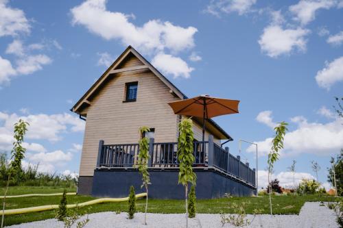 a house with a balcony on the side of it at Sielskie Chatki in Sandomierz