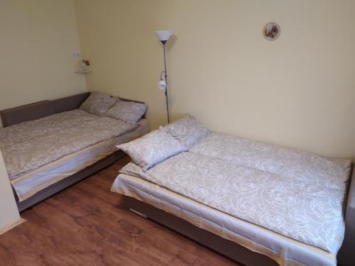 two beds sitting next to each other in a room at Rojas street apartments in Liepāja
