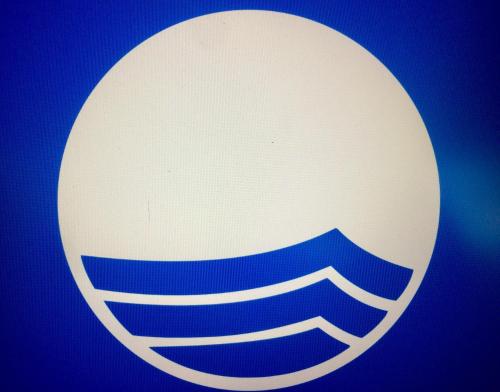 a close up of a logo on a blue background at Ferienhotel Alter Bahnhof garni in Prerow