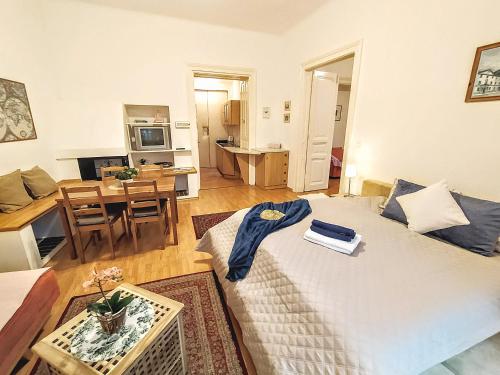 a living room with a large bed and a table at Apartments Historical Centre in Bratislava