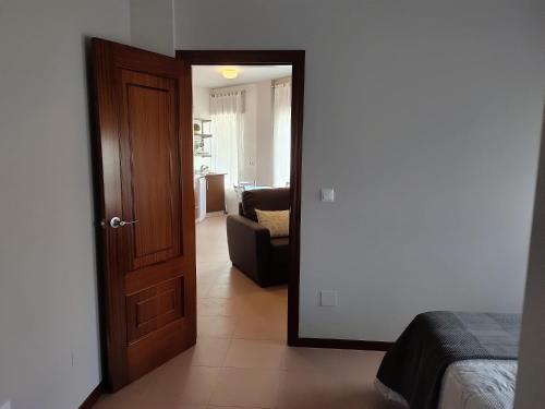 a room with a door leading to a living room at Apartamento Playa de Coira II in Portosin