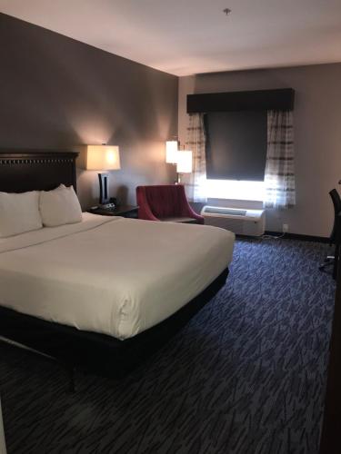 a hotel room with a bed and a television at La Quinta by Wyndham Abilene Mall in Abilene