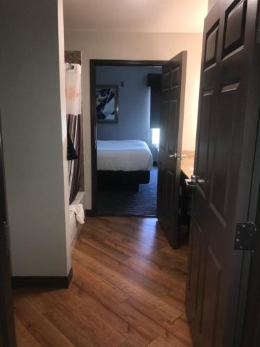 a room with a bedroom with a bed and a mirror at La Quinta by Wyndham Abilene Mall in Abilene
