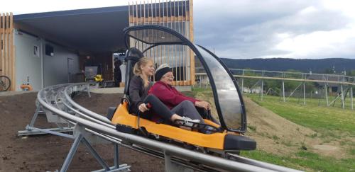 two women are riding on a roller coaster at Gasthof Klug zum Ehrensepp in Modriach