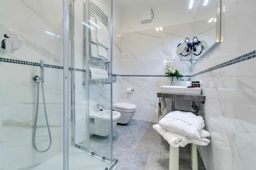 a bathroom with a shower and a sink and a toilet at Hotel La Meridiana in Venice-Lido