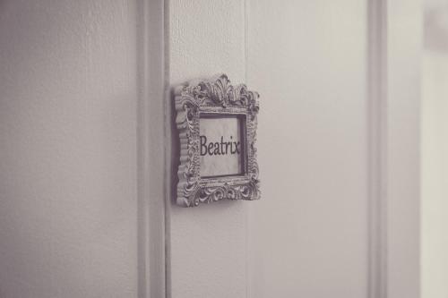 a mirror on a wall with a frame on a door at Puddle Duck Lodge – Adults Only in Bowness-on-Windermere