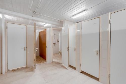 an empty room with white doors in a building at Safaritenten 'Woody' in Kuinre