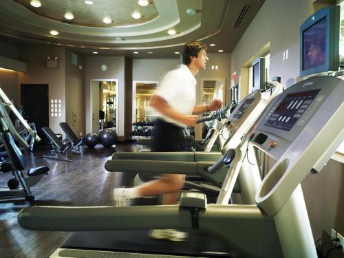 a man on a treadmill in a gym at Pan Pacific Vancouver in Vancouver