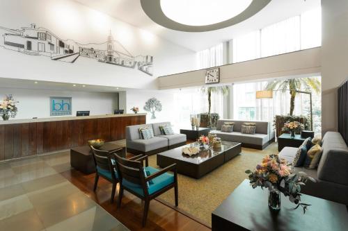 a large living room with couches and a table at Hotel bh Usaquén in Bogotá