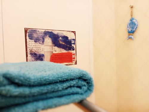 a pile of blue towels in front of a mirror at Nautic in Quarteira