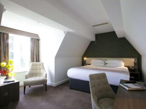 a bedroom with a bed and a table and chairs at Stourport Manor Hotel in Stourport