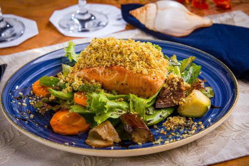 a blue plate of food on a table at Anttunina Pousada e SPA in Maragogi