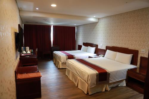 En eller flere senge i et værelse på Chuan Fu Hotel