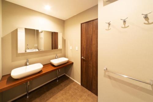 a bathroom with two sinks and a mirror at ENGAWA Nakano in Tokyo