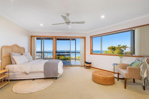 a bedroom with a bed and a view of the ocean at Seascape @ 19 Pindari - privacy, space, views in Dunbogan