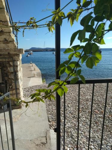 a view of the water from a balcony at Zanicovo beach apartment in Komiža