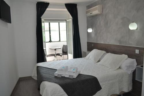 1 dormitorio con 1 cama grande y 2 plastificantes en Hostal Meyra, en Madrid