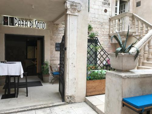 an entrance to a restaurant with a table and a door at Slavija Culture Heritage Hotel in Split